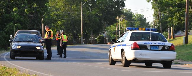 Officers stopping cars at a check point